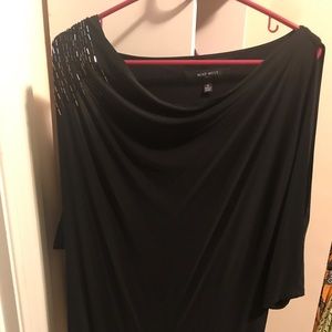 Black dress with slit sleeves and shoulder detail.